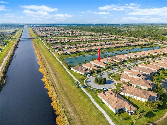 bird's eye view featuring a water view and a residential view