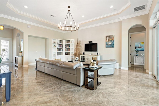 living room with arched walkways, visible vents, and a tray ceiling