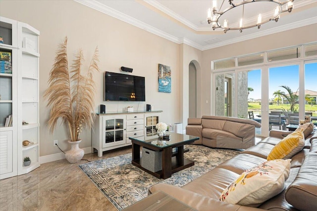 living area with arched walkways, ornamental molding, a chandelier, and baseboards