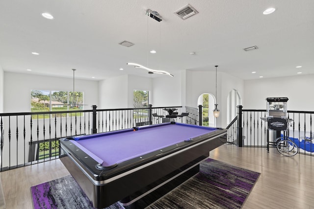 game room featuring pool table, a wealth of natural light, wood finished floors, and visible vents