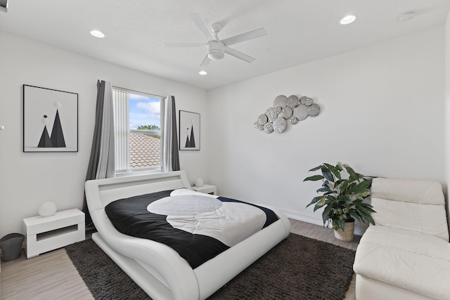 bedroom with a ceiling fan, recessed lighting, and wood finished floors