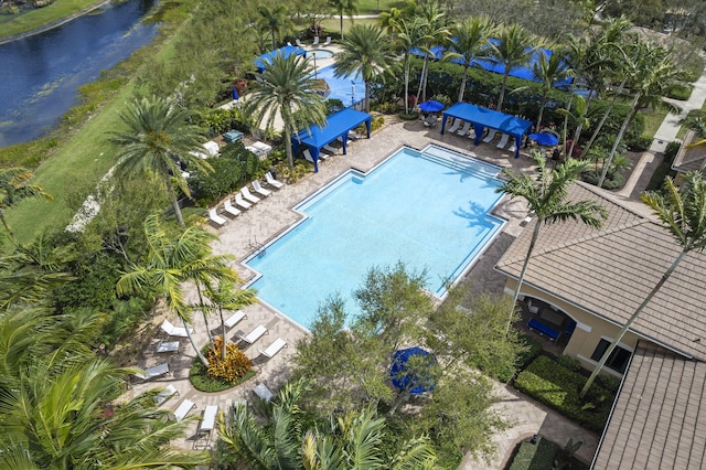 view of pool featuring a water view and a patio area