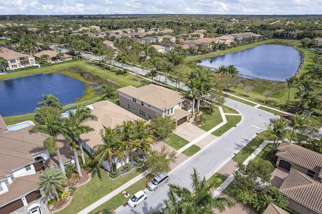 bird's eye view with a water view and a residential view