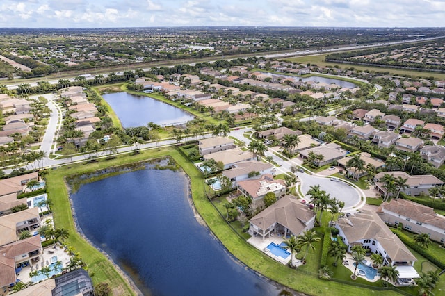 drone / aerial view featuring a water view and a residential view