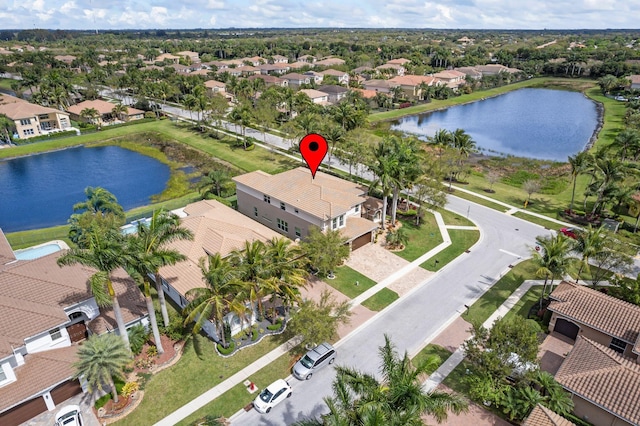 bird's eye view with a water view and a residential view