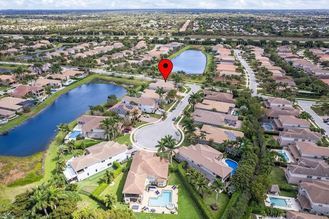 birds eye view of property with a water view and a residential view