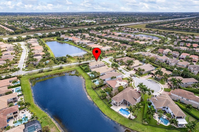 birds eye view of property with a water view and a residential view