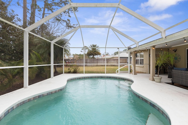 outdoor pool featuring glass enclosure, a patio area, and fence