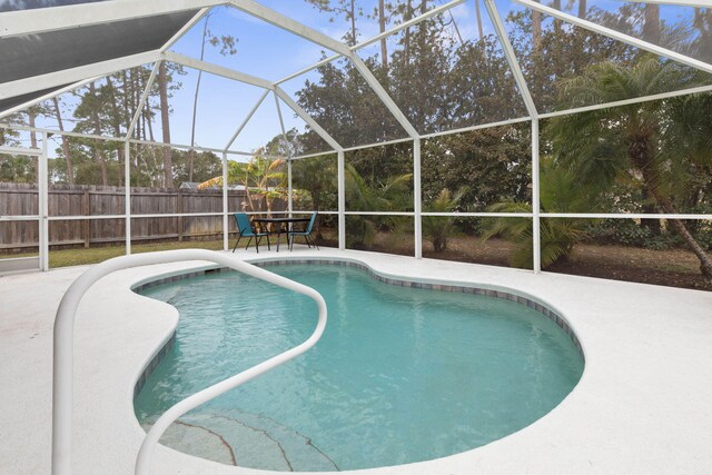 view of pool with a patio area, a lanai, a fenced in pool, and fence