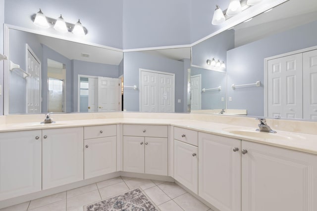 full bath with a closet, tile patterned flooring, and vanity