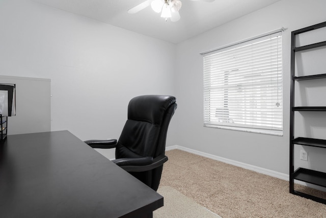 office space with light carpet, baseboards, and a ceiling fan