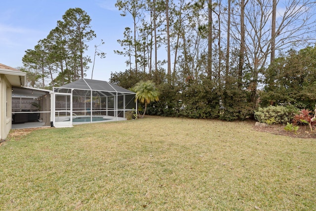 view of yard featuring a patio area, glass enclosure, and an outdoor pool