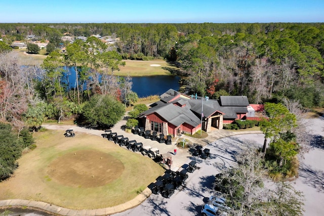 drone / aerial view featuring a water view and a forest view