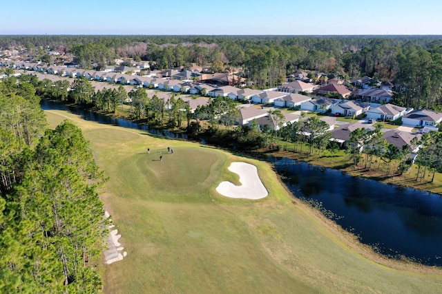 bird's eye view with a water view and golf course view