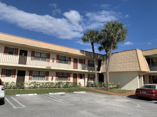 view of property featuring uncovered parking