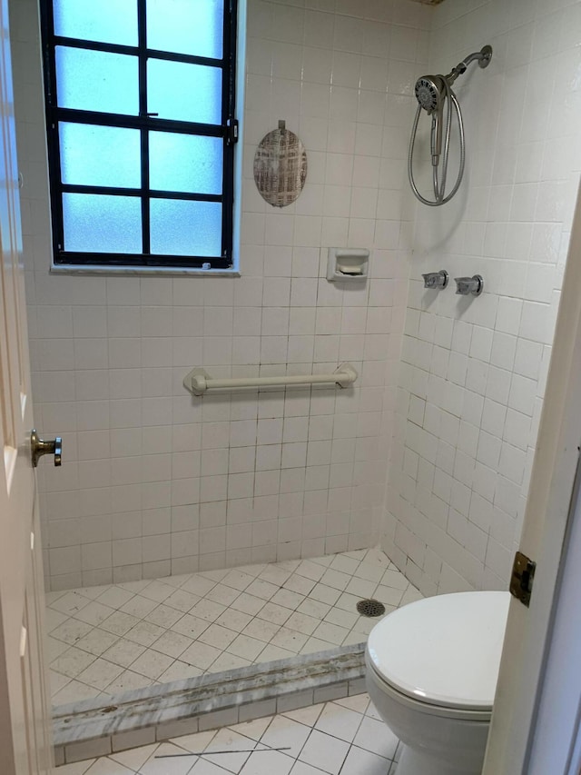 full bath featuring toilet, a shower stall, and tile patterned floors