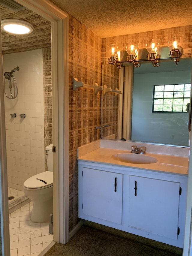 bathroom with toilet, a stall shower, vanity, a textured ceiling, and tile patterned floors