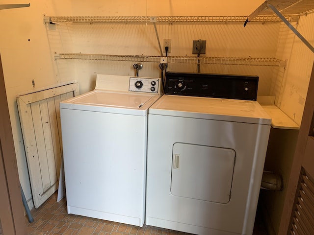 washroom with laundry area, brick floor, and independent washer and dryer