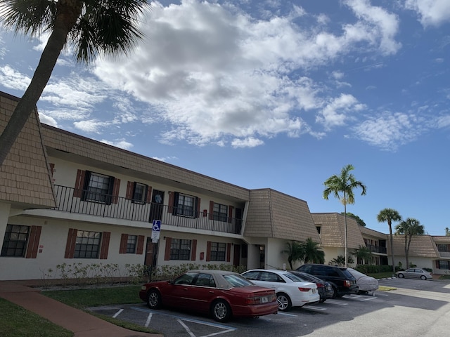 view of building exterior featuring uncovered parking