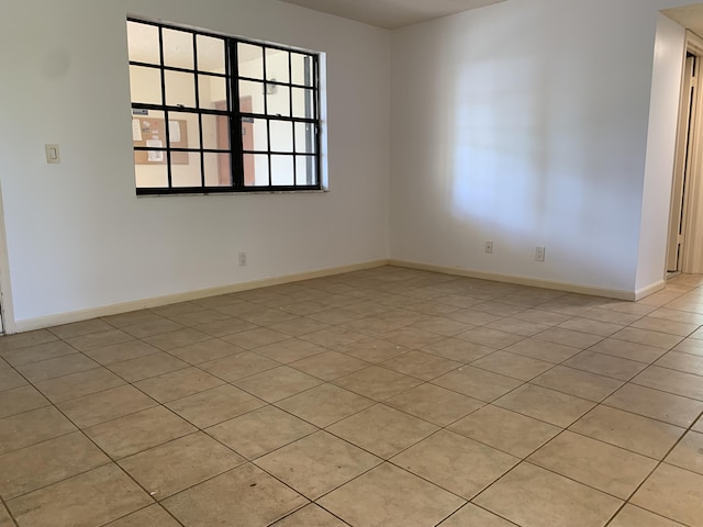 spare room featuring baseboards