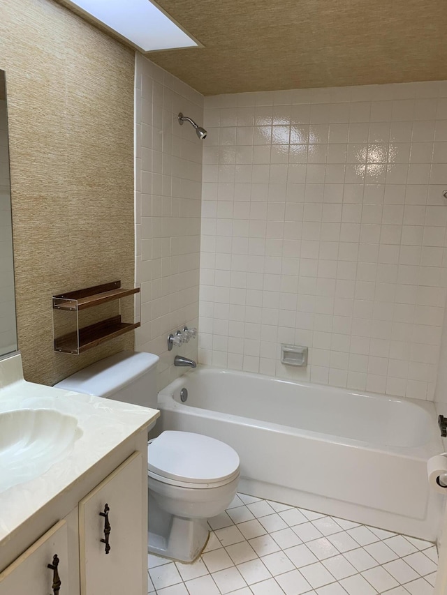 full bath with toilet, shower / bath combination, vanity, and tile patterned floors