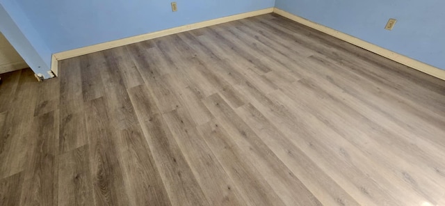 interior details featuring wood finished floors and baseboards