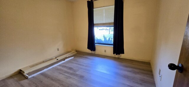 5724 SE Collins Ave, Stuart, FL 34997 - unfurnished room featuring wood finished floors, baseboards, and baseboard heating