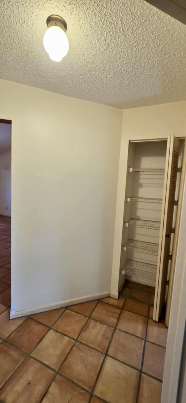 5724 SE Collins Ave, Stuart, FL 34997 - hallway featuring tile patterned flooring and a textured ceiling