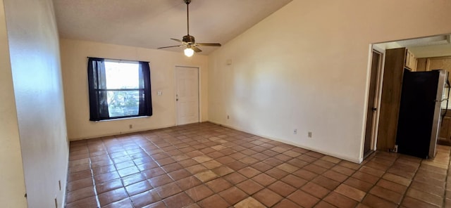 empty room with lofted ceiling, ceiling fan, and tile patterned floors