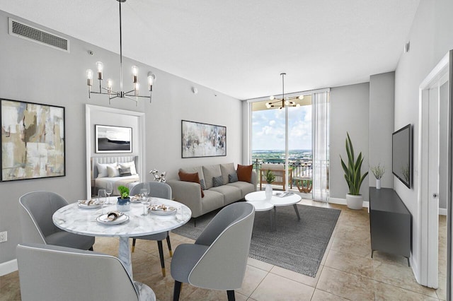 dining room featuring expansive windows, baseboards, visible vents, and an inviting chandelier