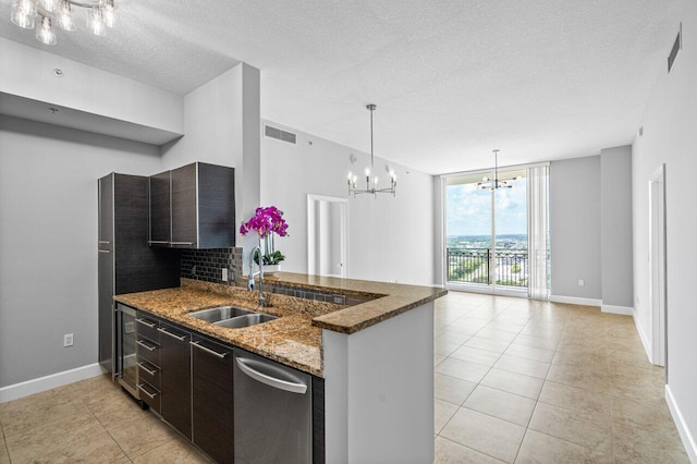 kitchen featuring a chandelier, a sink, visible vents, dark brown cabinets, and dishwasher