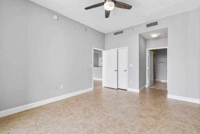 unfurnished bedroom with visible vents, ceiling fan, a textured ceiling, and baseboards