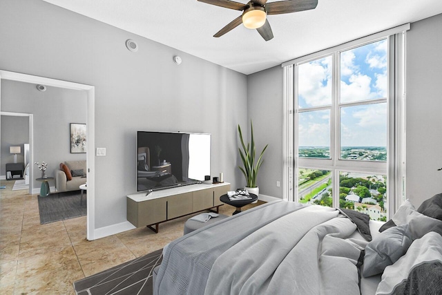 bedroom featuring light tile patterned floors, ceiling fan, floor to ceiling windows, and baseboards