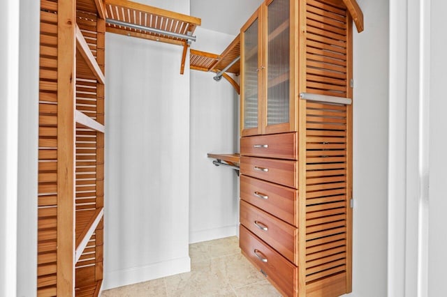 walk in closet featuring light tile patterned flooring