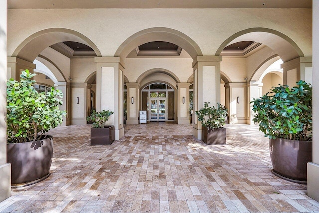 property entrance with french doors, a patio area, and stucco siding