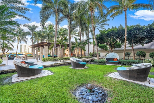 surrounding community featuring a pergola and a lawn