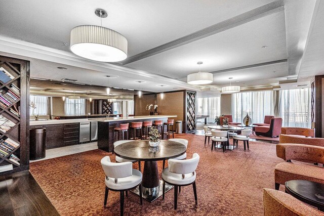 dining area with indoor wet bar and wood finished floors