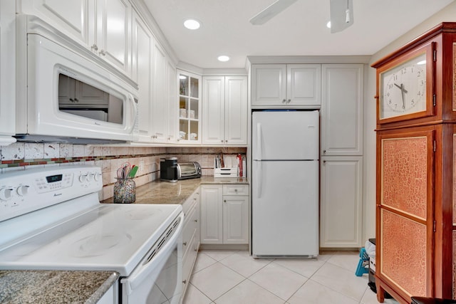 kitchen with backsplash, glass insert cabinets, light tile patterned flooring, ceiling fan, and white appliances