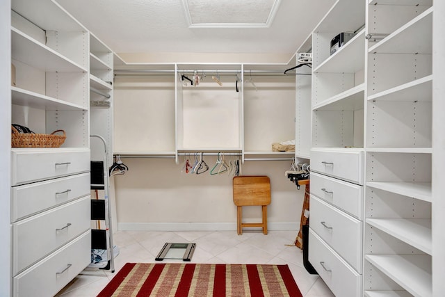 spacious closet featuring light tile patterned floors