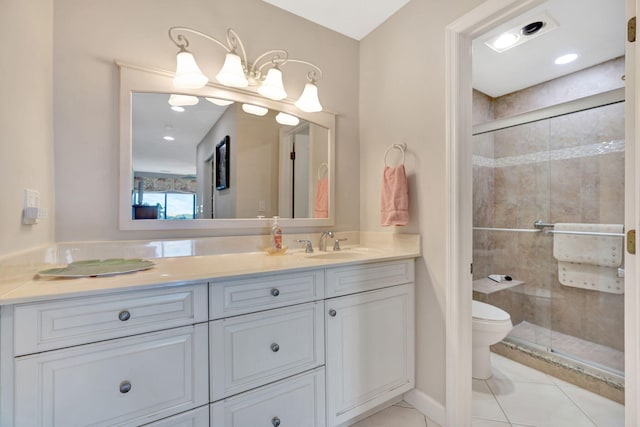 bathroom with toilet, a shower stall, vanity, tile patterned flooring, and baseboards