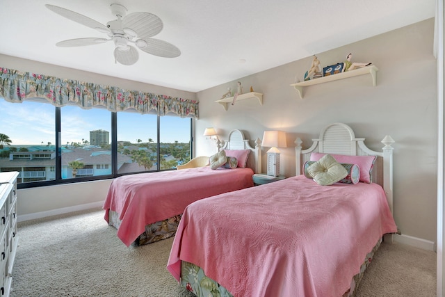 bedroom with a ceiling fan, baseboards, and carpet flooring