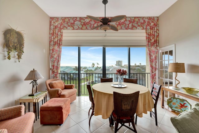 dining space featuring a ceiling fan and light tile patterned floors