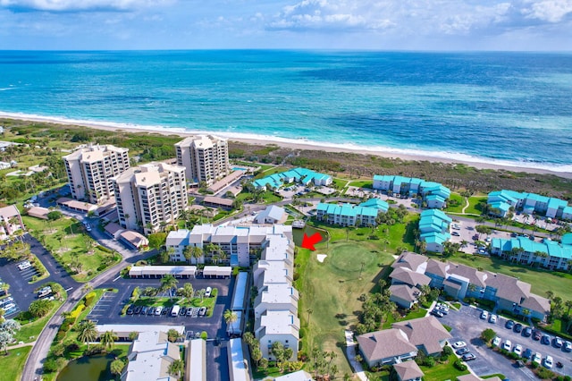 drone / aerial view with a water view and a beach view