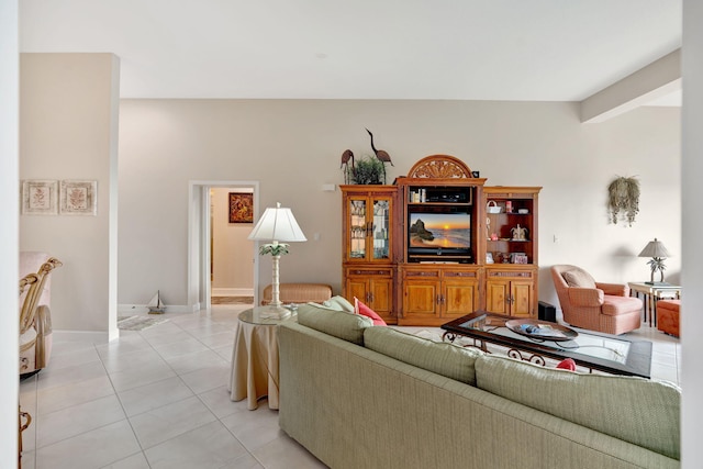 living area with light tile patterned flooring and baseboards