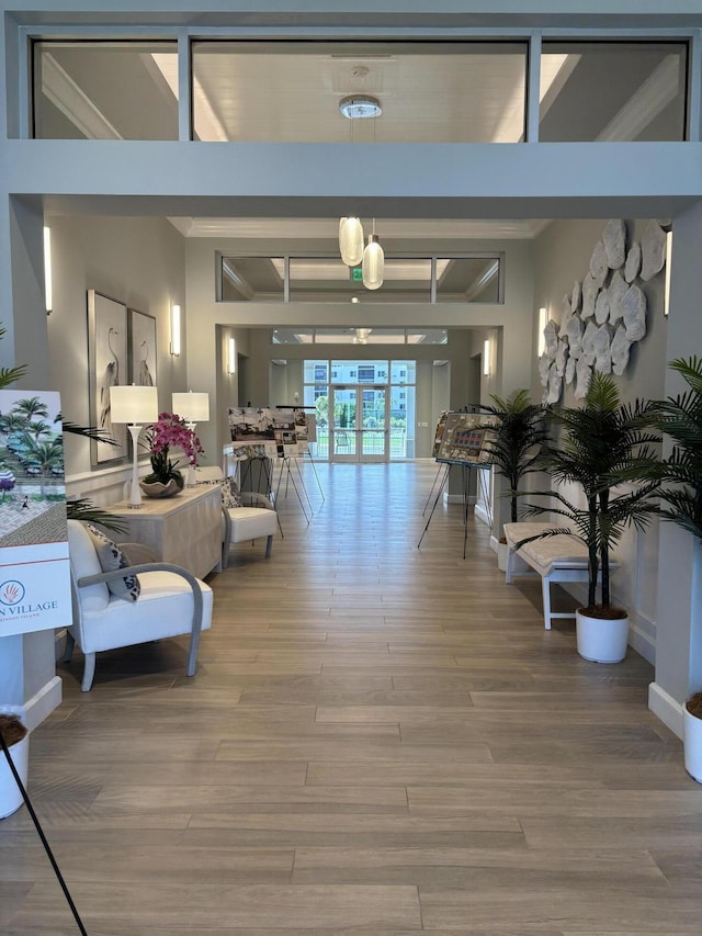 hallway featuring french doors, beamed ceiling, and wood finished floors