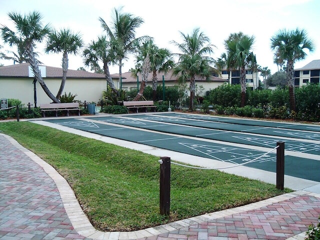 view of community featuring a yard and shuffleboard