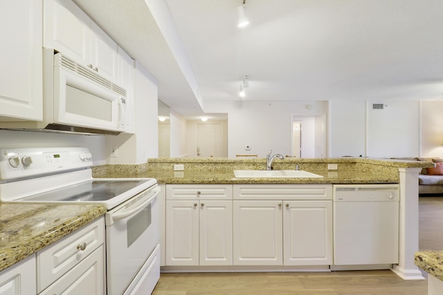 kitchen featuring light wood finished floors, visible vents, white cabinetry, a sink, and white appliances