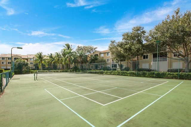 view of tennis court with fence