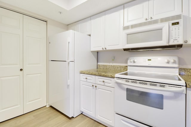 kitchen featuring white appliances, light wood-type flooring, white cabinetry, and light stone countertops