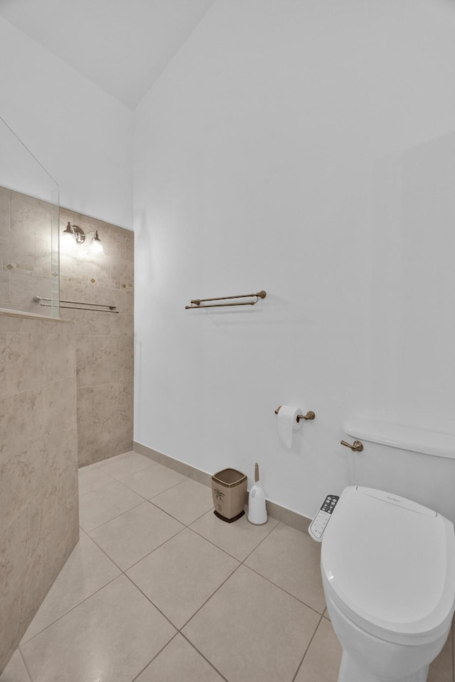 bathroom with toilet, tile patterned flooring, and baseboards